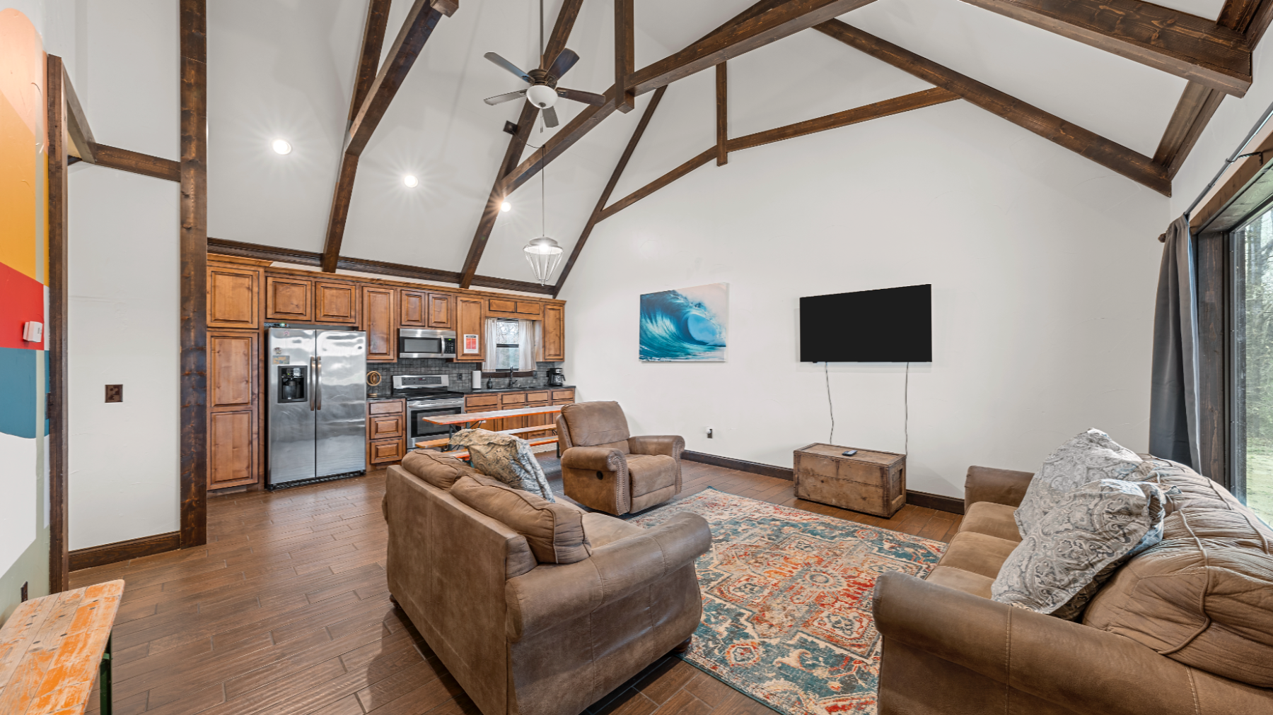 a view of a living room filled with furniture and a fireplace